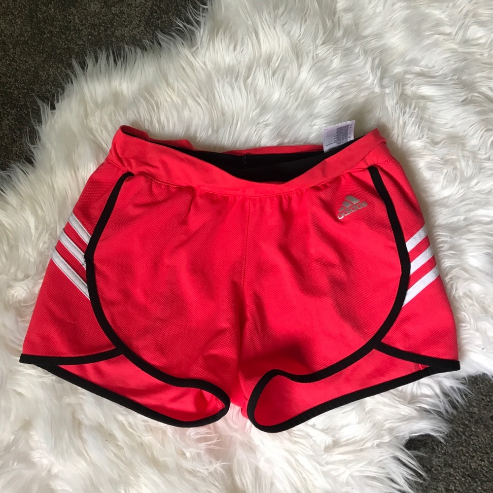 Adidas pink short, black and white stripes.